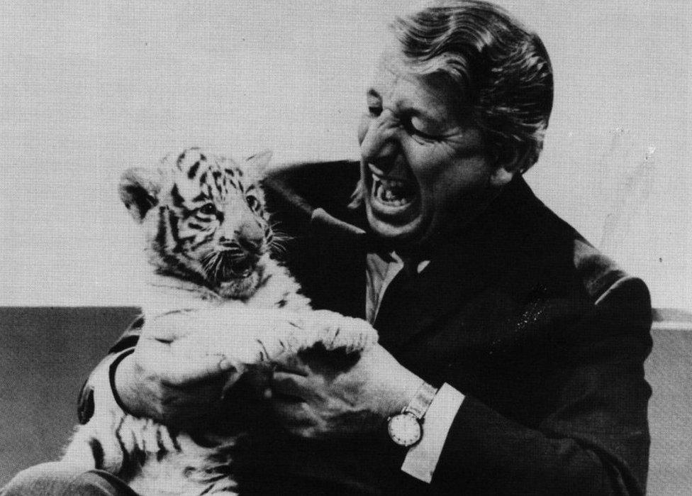 Johnny Morris with a baby white tiger