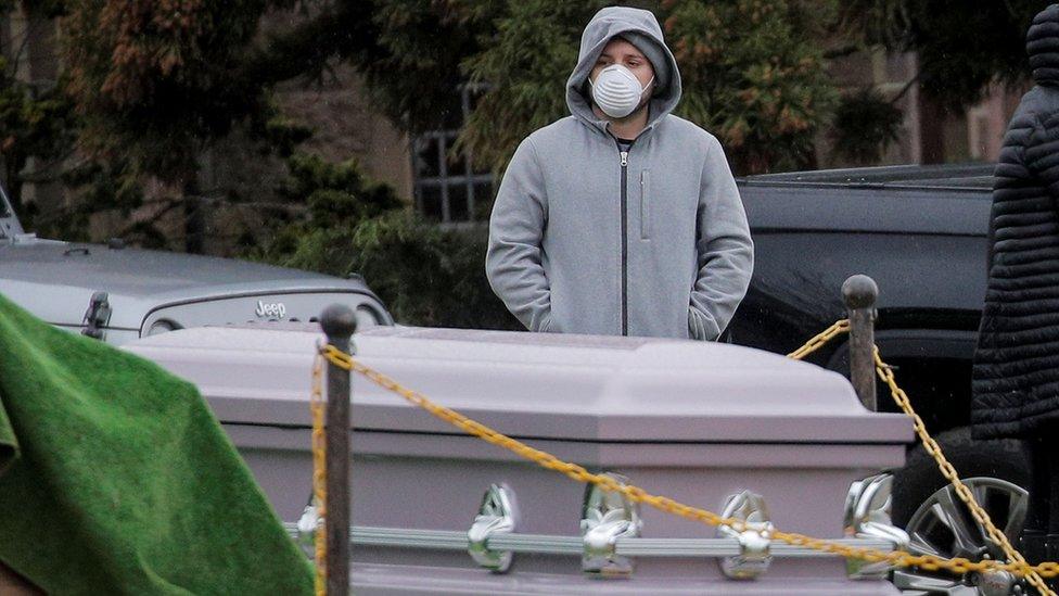 Mourners attend a funeral at The Green-Wood Cemetery, amid the coronavirus disease in Brooklyn, New York