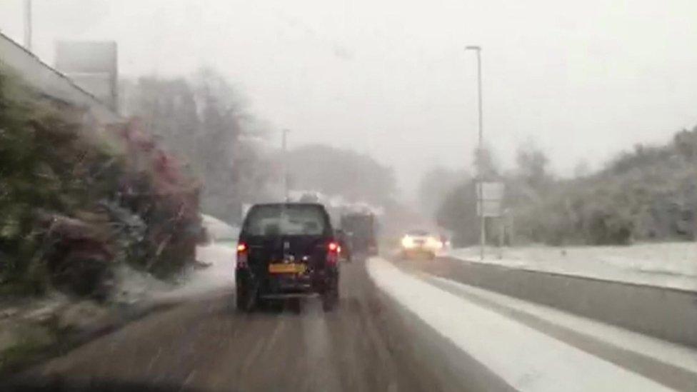 snowy road scene shot from dashboard