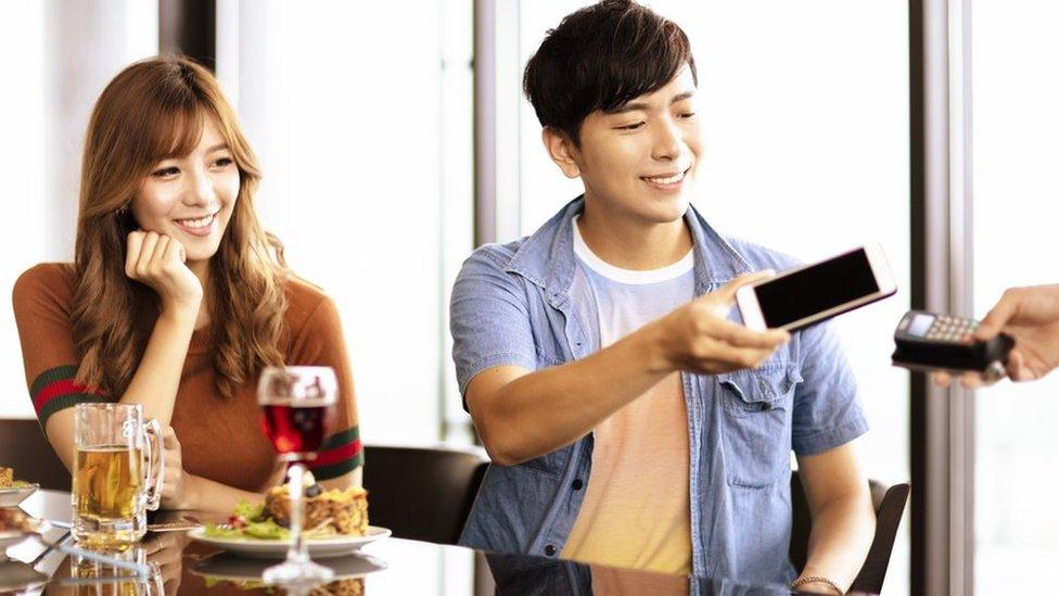 Man paying for meal in restaurant