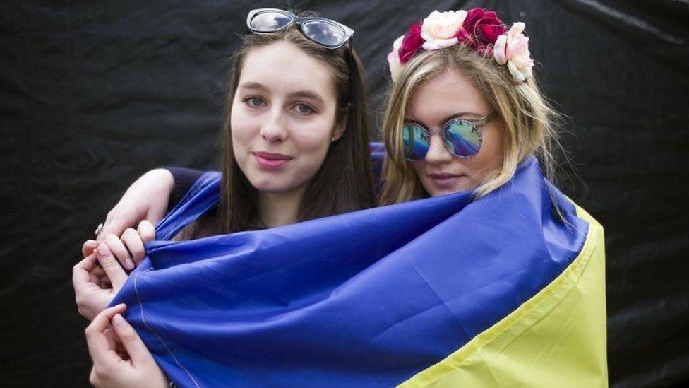 Sofia Pavlovska and Anastasiya Dusanska of Ukraine, who both live in The Hague, pose during a demonstration on the EU referendum at the Dam Square in Amsterdam (03 April 2016)