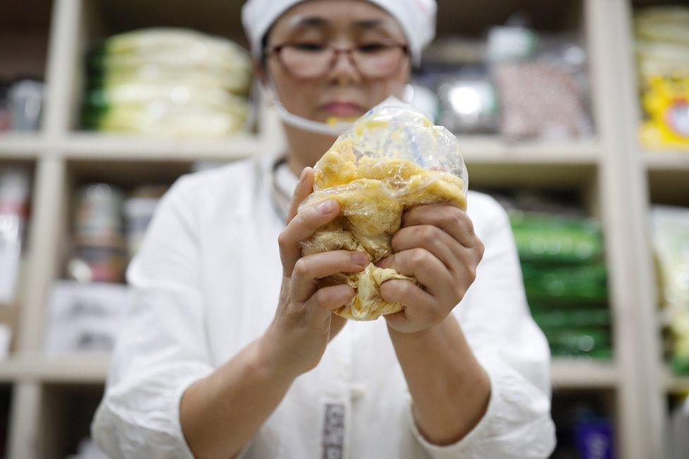 North Korean defector Hong Eun-hye demonstrates how North Korean people make rice cakes with corn powder at her North Korean food store in Seoul, South Korea, 28 September 2017.