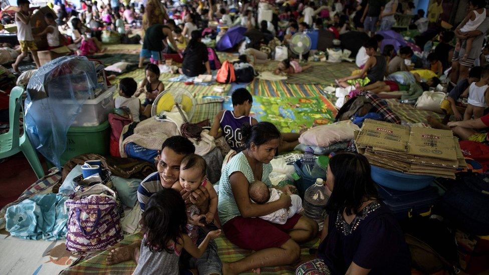 Flood-affected residents are seen at an evacuation centre