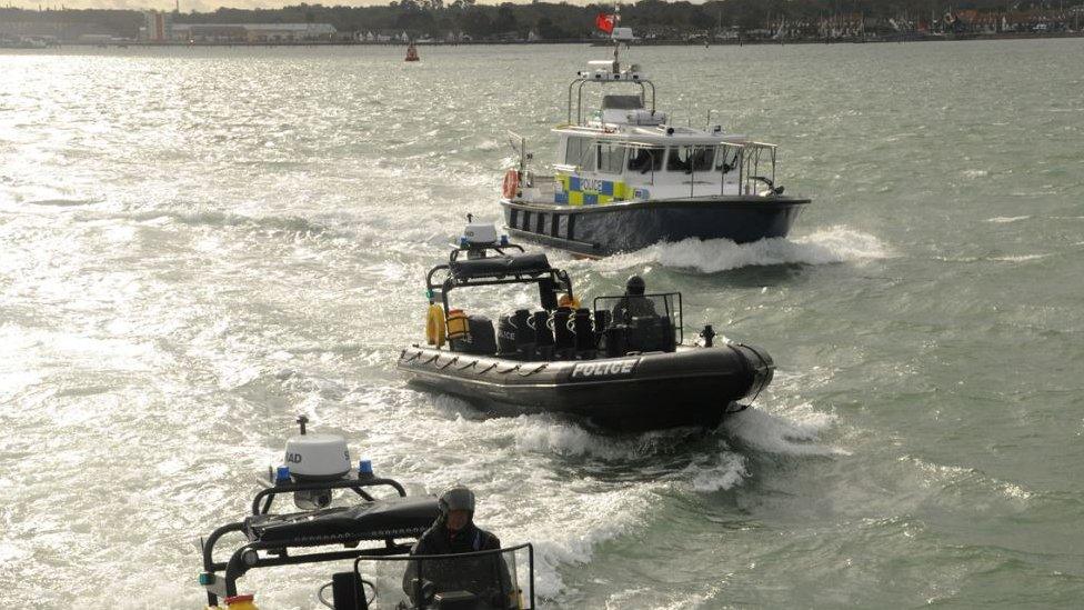 Three police boats on the water