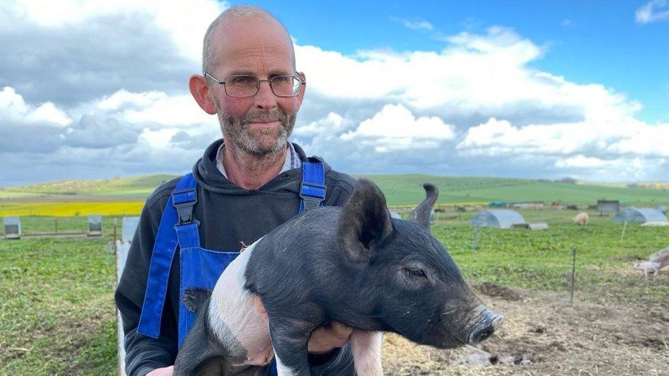 Cameron Naughton holding pig