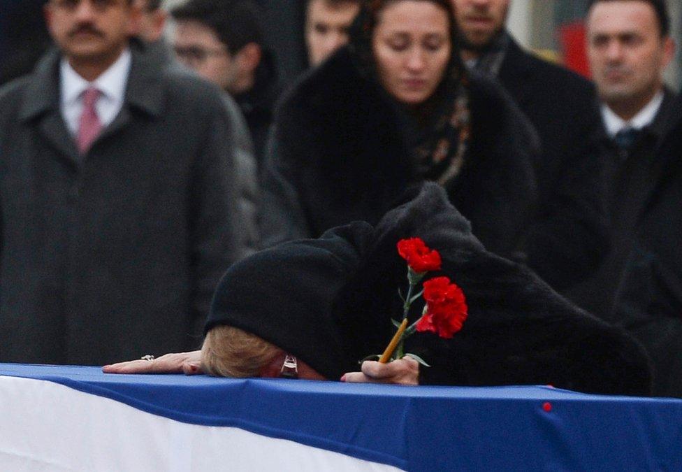 Andrei Karlov's widow Marina weeps on his coffin