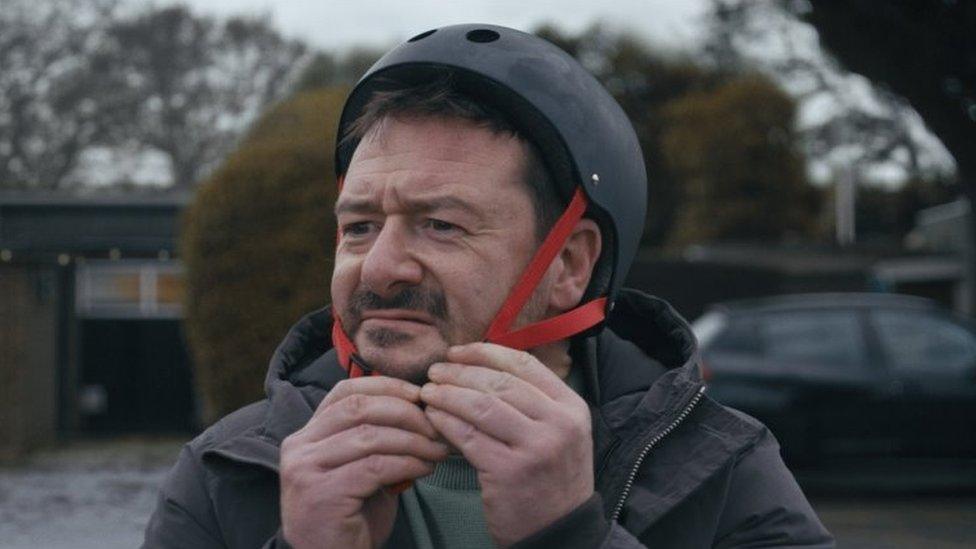 Man putting helmet on