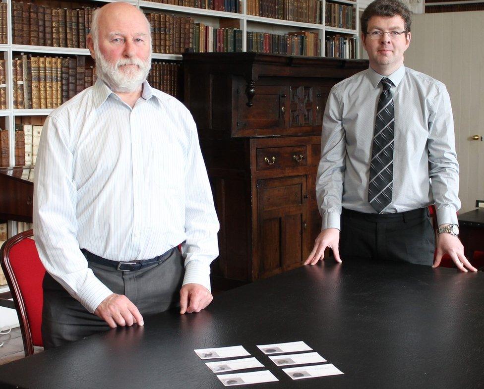 Alan Dunlop presenting the coins to the library's director Robert Whan