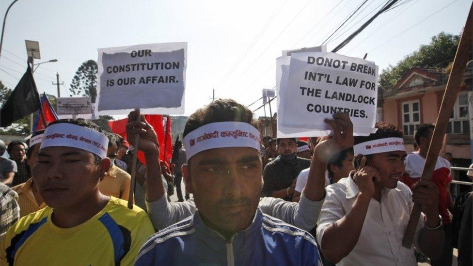 In this Wednesday, Sept. 30, 2015 photo, protesters affiliated with Maoist Communist Center Nepal hold placards against India near the Indian embassy during a protest in Kathmandu, Nepal.