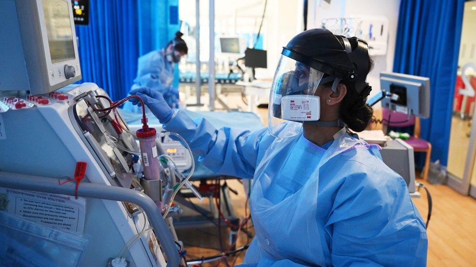 Clinical staff wear Personal Protective Equipment (PPE) as they care for a patient at the Royal Papworth Hospital in Cambridge.