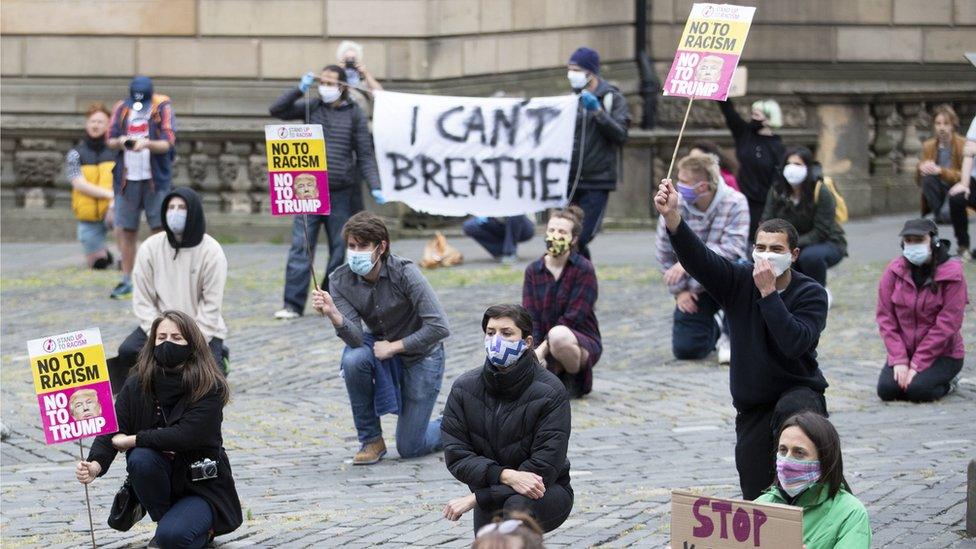 Demonstrators take part in the Take A Knee for George Floyd solidarity protest organised by Stand Up To Racism Scotland, outside St Giles" Cathedral in Edinburgh in memory of George Floyd who was killed on May 25 while in police custody in the US city of Minneapolis.