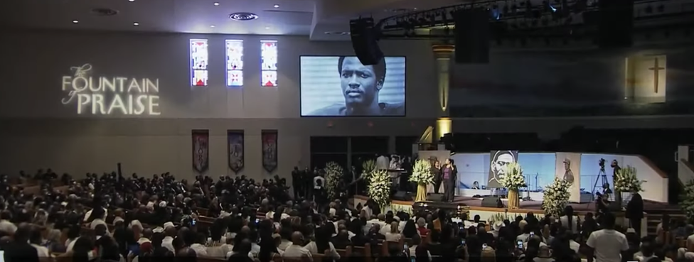 Mourners gathered at George Floyd's funeral, with an incorrect image on a big screen