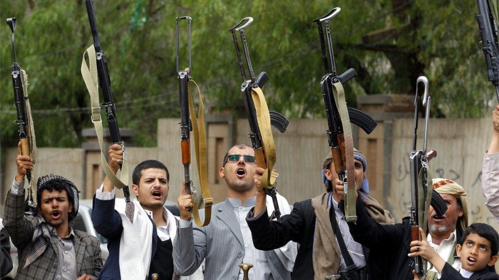 Armed tribesmen, loyal to the Shia Houthi rebels, shout slogans and brandish weapons during a gathering to show support to the rebels, in Sana'a, Yemen, 21 April 2016