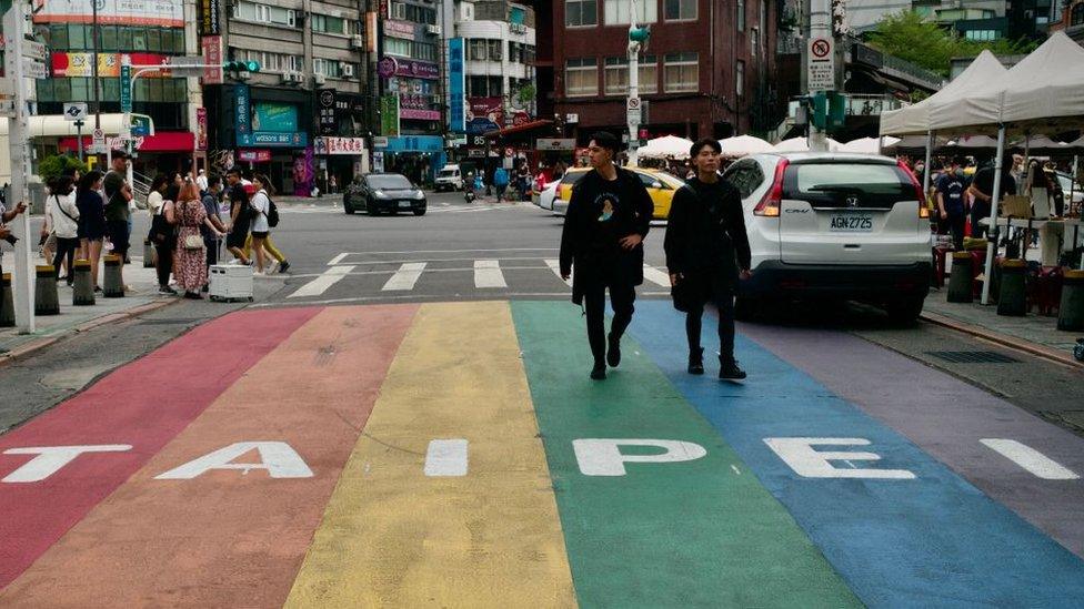 People walking down a street at the Ximen district in Taipei