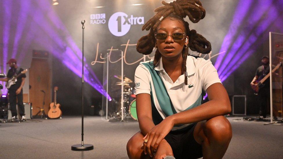 Little Simz, crouched infront of live lounge