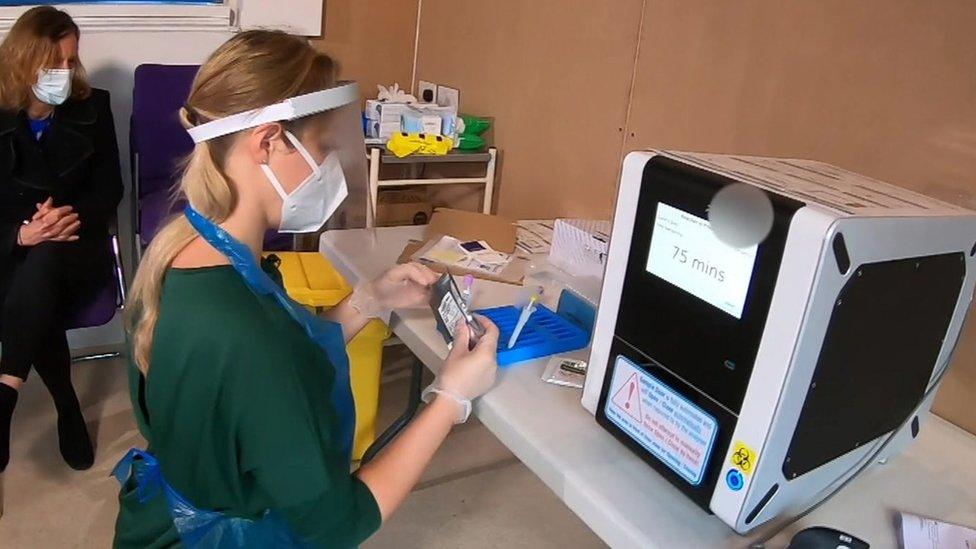 Care home staff member with test machine