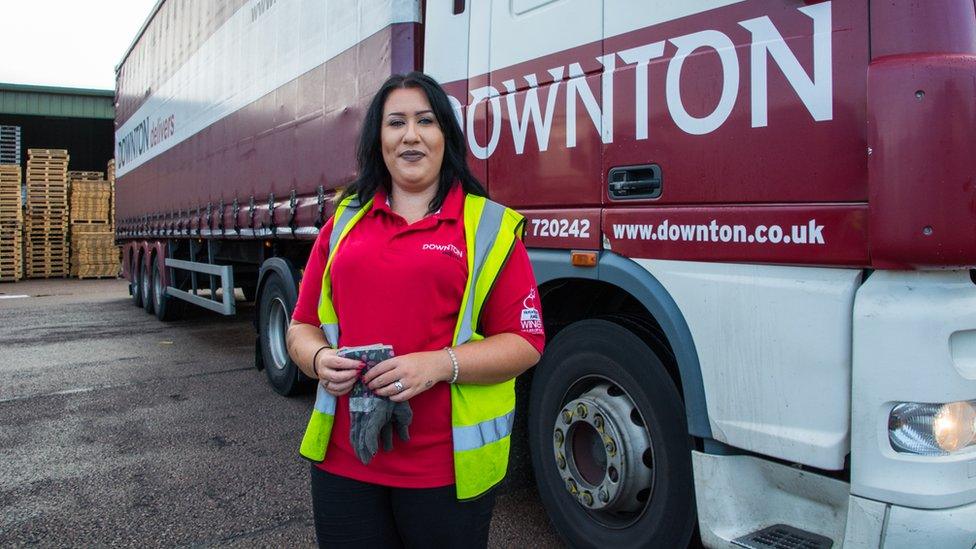 Leonie John in front of a lorry and trailer