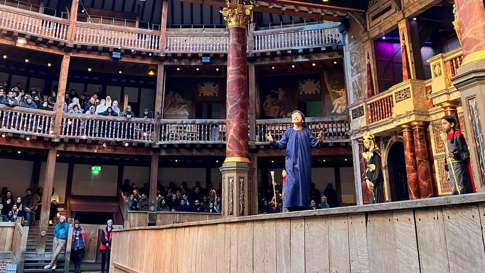 children perform on stage at the Shakespeare's Globe in front of audience