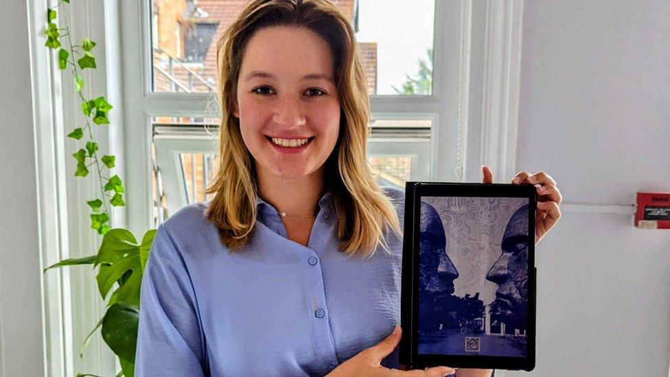 Dominika Kalinowska holding a piece of artwork she drew