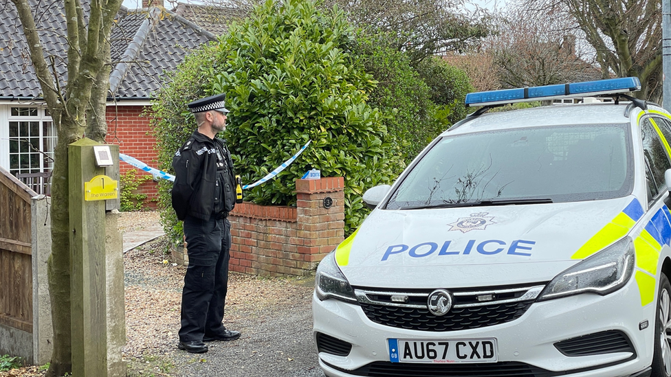 A police man and a police car outside a property in The Warren, Cromer. Norfolk