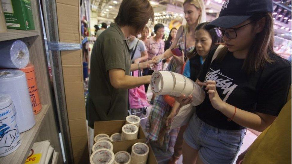 Hong Kong residents buy tape to secure their windows as Typhoon Mangkhut approaches, 15 September 2018