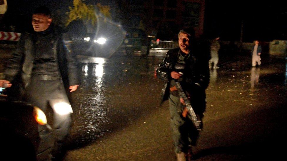 Afghan security personnel check a vehicle along a street after an unknown number of assailants mounted the attack from a building close to the Indian consulate in Mazar-i-Sharif, prompting Afghan forces to cordon off the area, late on January 3, 2016.