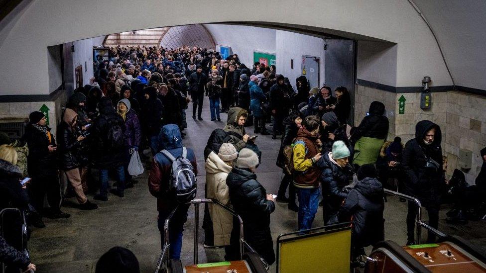 A crowd of people take shelter in a Kyiv metro station