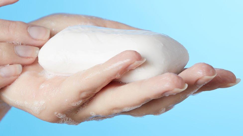 Hand holding a bar of soap