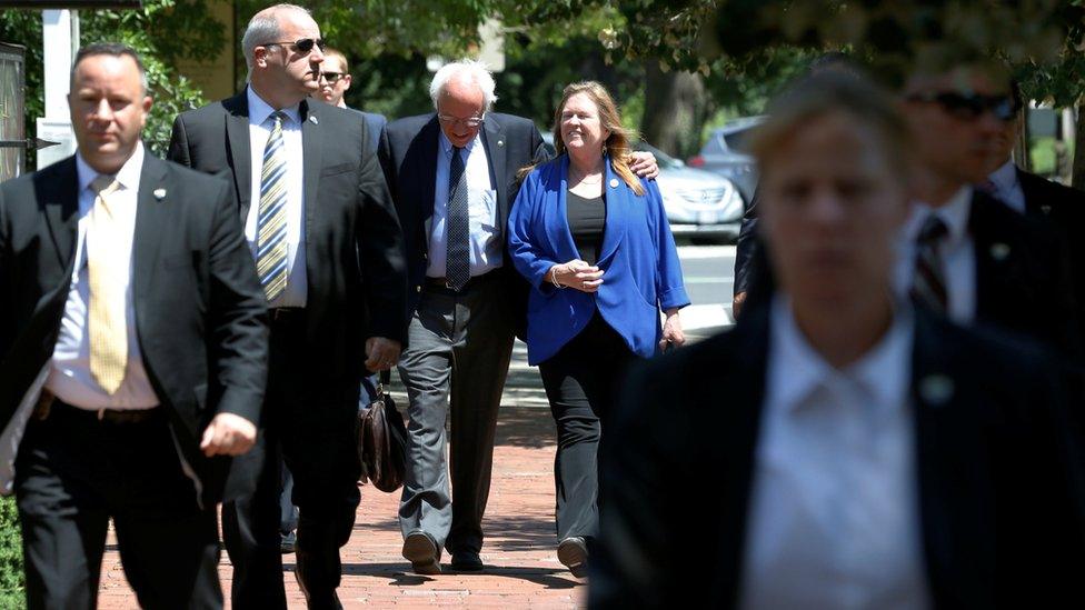 Secret Service agents escort Sanders as he walks with his wife