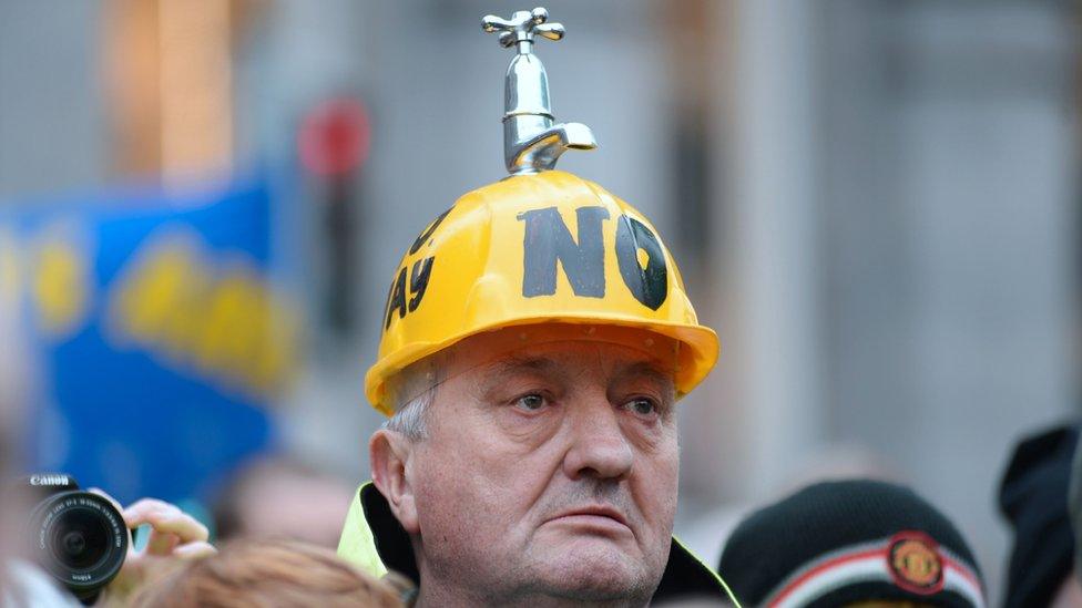 A demonstrator wears a hard hat with a tap on the top during a march and rally organized by Right2Change and Right2Water in Dublin, Ireland (20 February 2016)