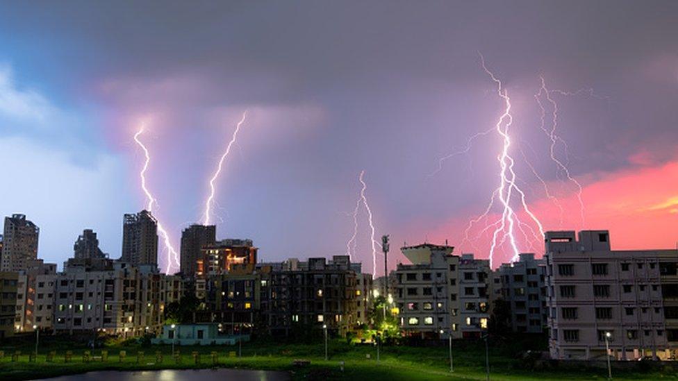 Panoramic view of lightning over illuminated city against sky at night,Kolkata,West Bengal