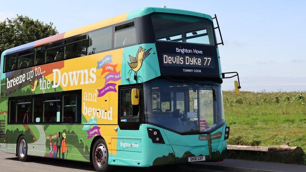 Breeze up to the Downs bus driving along, with green scenery outside