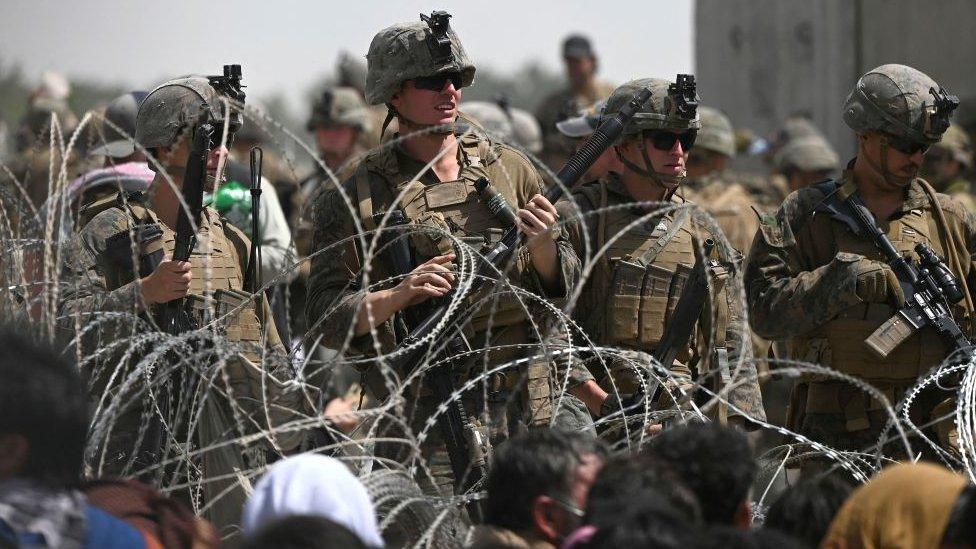 soldiers-standing-together-behind-barbed-wire