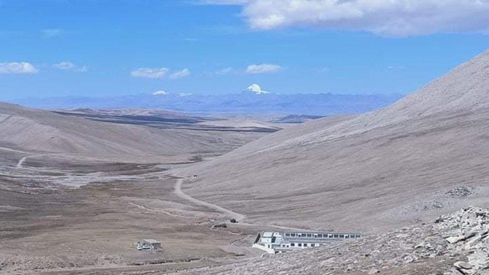 The border area in Humla, with Chinese buildings in the foreground and snow-covered Mount Kailash in the distance