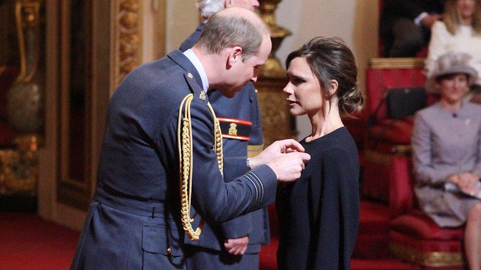 Victoria Beckham receives her OBE from Prince William