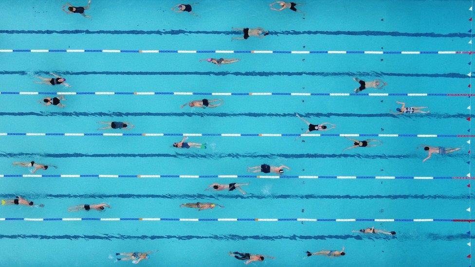 A drone photo of people swimming in lanes at a Lido