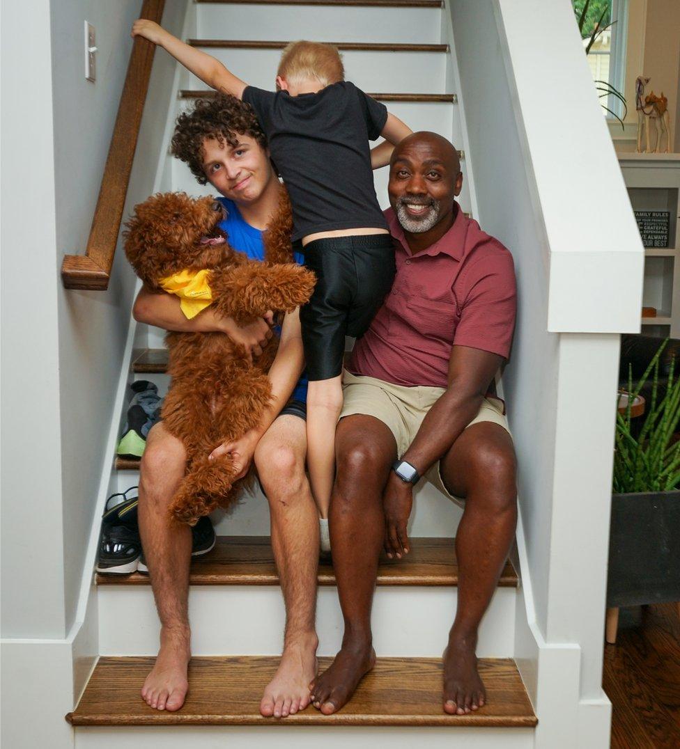 Peter, Anthony and Johnny on the stairs with their dog