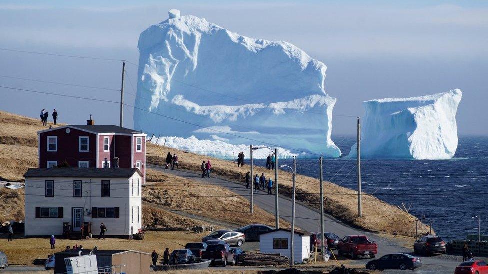 Residents view the first iceberg of the season as it passes the South Shore, also known as "Iceberg Alley", near Ferryland Newfoundland, Canada April 16, 2017.