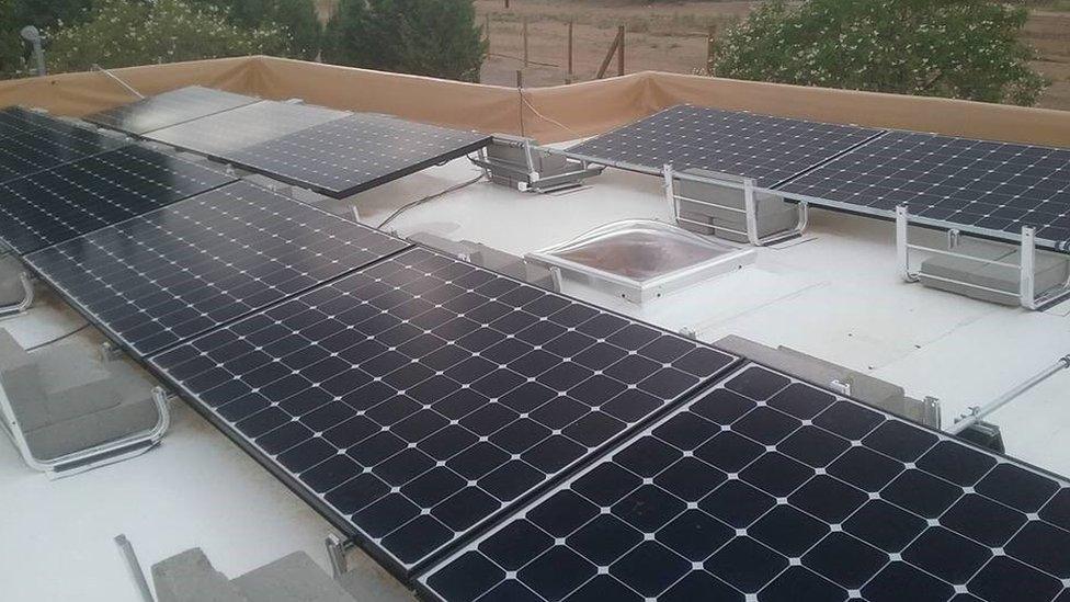 Solar panel covered roofs are painted white in Albuquerque