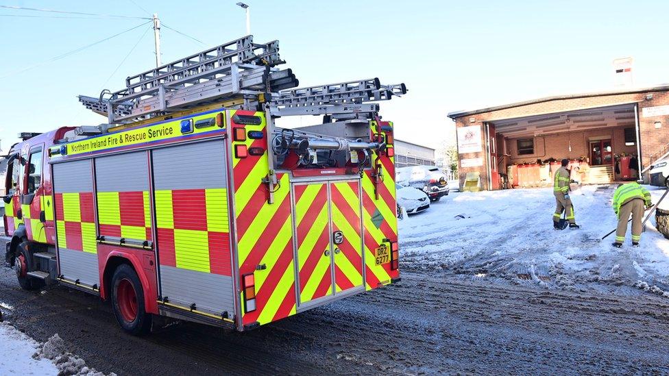 Fire officers clearing snow at a Crumlin fire station