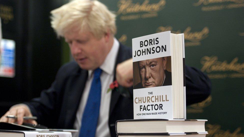 Boris Johnson signing copies of his book