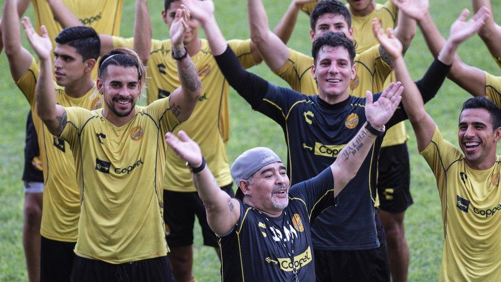 Argentine legend Diego Maradona smiles with the players during his first training session on 10 September 2018