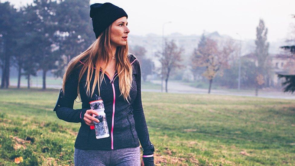 Woman in park with bottle in winter