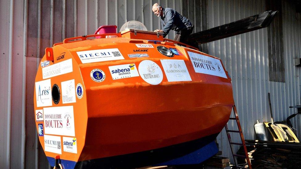 Jean-Jacques Savin works on the construction of his barrel at the shipyard in Ares, south-western France, 15 November 2018