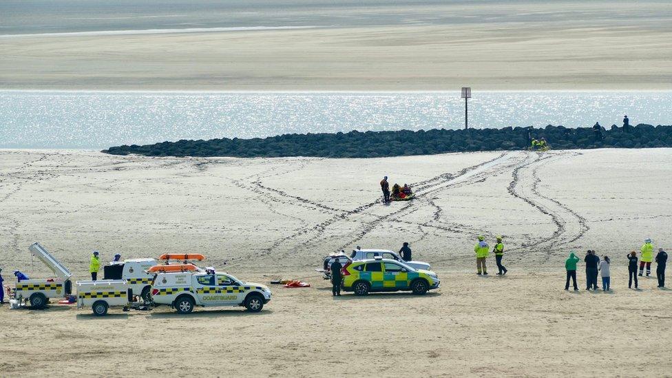 Rescuers using a sled to rescue the family