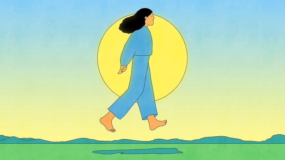 Illustration showing woman walking in front of a sun