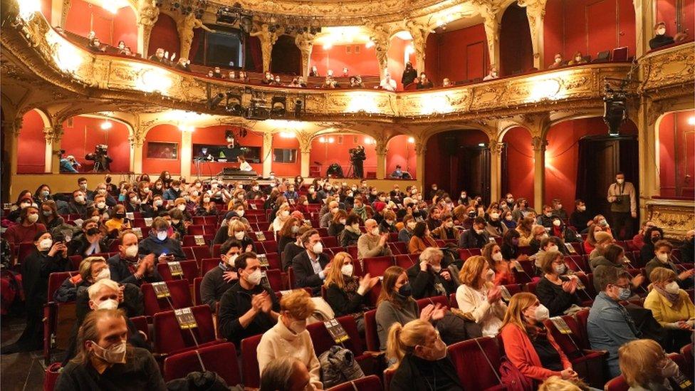 Members of the audience wear protective masks and sit spaced apart at the first in-person performance at the Berliner Ensemble theatre in 2021 during the coronavirus (Covid-19) pandemic, in Berlin, Germany, 19 March 2021