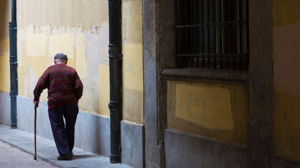 Elderly man walking away