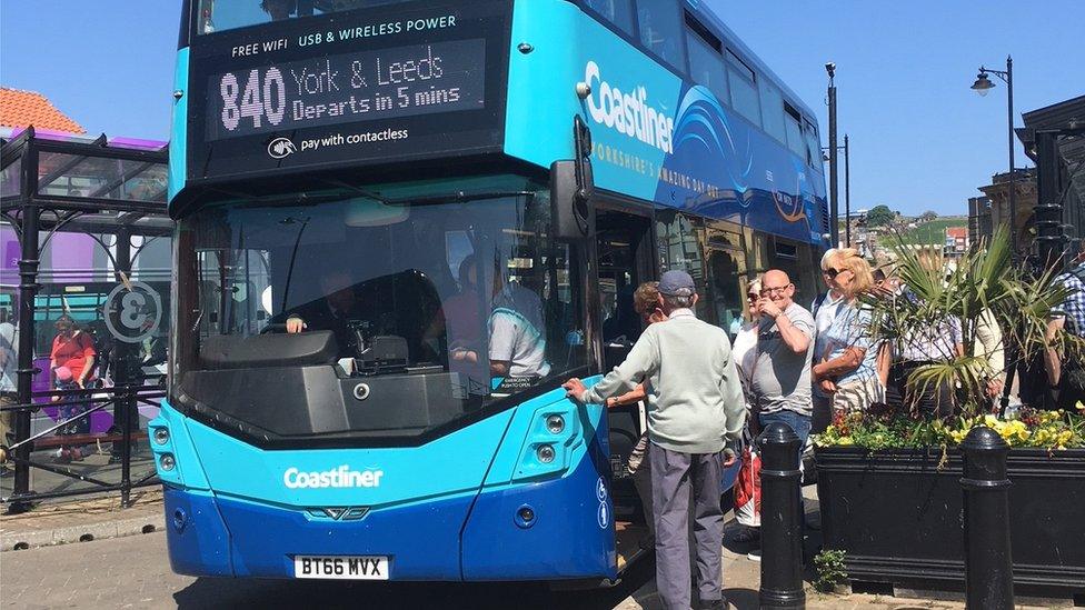 Passengers getting on bus