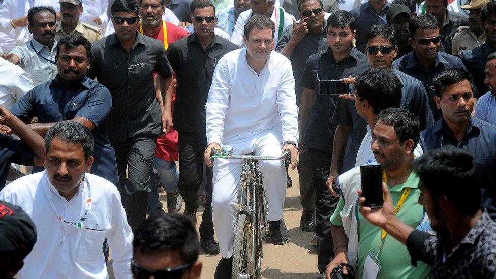 Indian National Congress president Rahul Gandhi rides a bicycle during an election campaign for the forthcoming Karnataka Legislative Assembly elections on May 7, 2018